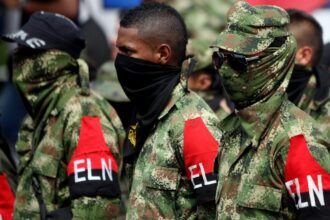 Guerrilleros del ELN con brazaletes rojos y negros durante una formación en Colombia